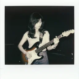 a black and white polaroid of a female japanese musician playing an electric guitar, 1 9 7 0 s