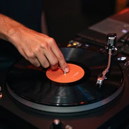 satan dj with hand on record spinning
