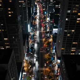 a city street at night, raining, photograph, cyberpunk, sharp focus, intricate detail, drone shot,