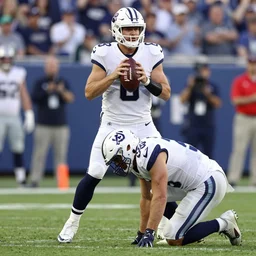 a photo of a decapitated quarterback in the background with an upset offensive tackle in the foreground, sports photography