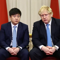 Asian Boris Johnson sitting next to African Boris Johnson