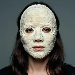 portrait of a woman wearing a gimp mask, photo by annie leibovitz