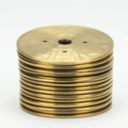 a few brass discs with punch holes stacked, front view, straight composition 1 9 9 0, life magazine reportage photo