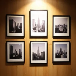 pictures hanging on a wooden wall lit by the high key light.