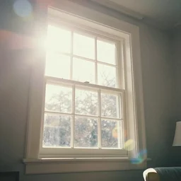 photo of interior design house, super detail of a white window in a living room, close up, view from bottom, sunday morning, sun, bokeh, lens flare hit camera, yellow light, diffuse light, instagram trending picture, instagram filter, foggy, vintage photography, grainy, light leaks, polaroid