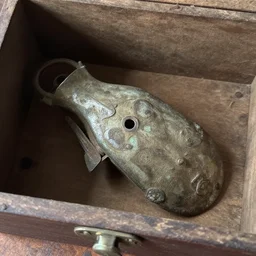 i've found this weird old object in my grandmother box, does anyone know what it is?