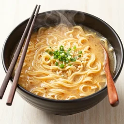 a delicious bowl of steamy hot ramen noodles with chopsticks placed at the side