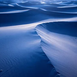 as the light rises the edges of the desert dunes glow blueish, the sunlight twisted and refracted. artstation, cgsociety, blue color scheme.