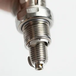 macro photography sparkplug bent diode plain background