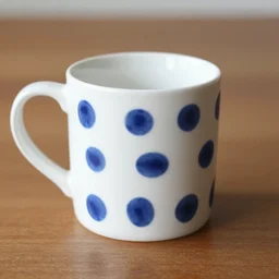 a white mug with blue dots