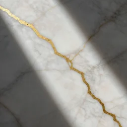a photo of beautiful marble with veins of gold running through it.