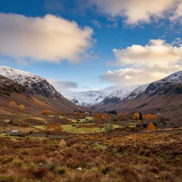 autumnal scottish valley view with snowy mountains in the background and piercing blue sky with citrus clouds by erin hanson and tyler edlin