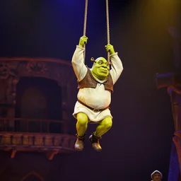 shrek on a trapeze, swinging midair, at a cirque du soleil show, stage lighting, action shot, 4 k, high res