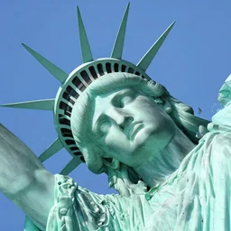 statue of libertys head lying sideways with crown is broken off , low angle