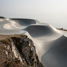 a skate park on the edge of a cliff leading to hell