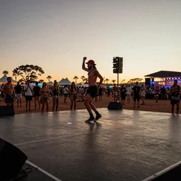 low angle shot of dancefloor at festival in the desert, doof, clean, celebration, party, night time australian outback, XF IQ4, 150MP, 50mm, F1.4, ISO 200, 1/160s, sunset