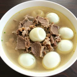 Cooked beef mixed with cooked pork and cooked eggs in a soup
