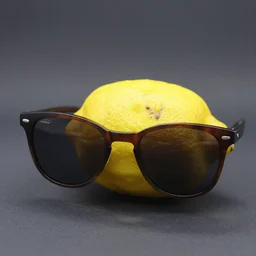 a photograph of a lemon with dark sunglasses