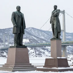 a monument of lenin next to a suspension bridge with a train, snowy mountains, detailed, sharp focus