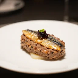 a photo of plate of smoked mackerel pate from a michelin star restaurant