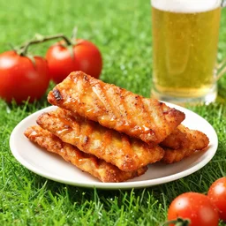 photo of tasty stake with green grass, tomatoes and glass of beer