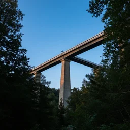 tall bridge for trains, in the forest, blue sky, summer evening, kenton nelson