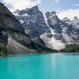 a turquoise placid lake in the forground with a towering mountain in the background, artstation, highly detailed,