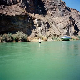 photo of green river, wyoming cliffs. an old man in a trench coat and chrome spaceship like a ellips stands still very far away in the distance, facing at the camera. midday sun. hot and dry conditions. kodak ektachrome 8 k, hyper detailed, 3 5 mm film grain