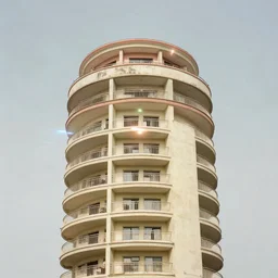 a tower covered by balconies with bleached colours, mamiya, 8 5 mm, f 1. 7, fully frontal view, uniform plain sky, light leaks, digital glitches, photographed by julie blackmon