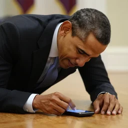 Barack Obama crying because he dropped his mobile phone on the floor. His phone is flat on the floor.