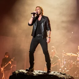 dweyn the rock jonson standing on a rock and singing in a rock concert