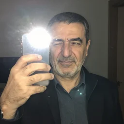 my Kurdish dad accidentally taking a selfie with the front camera, squinting because the camera flash is so bright in his face