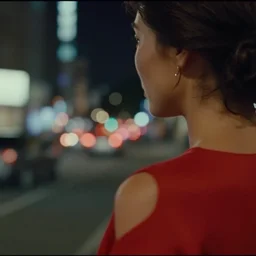 head and shoulder still of a woman in a red dress. city at night in the background. cinemascope. anamorphic footage, bokeh, 4 k.