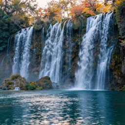 landscape photography, wall of waterfalls, high waterfalls and colors plants, plants, beautiful lake on the bottom with light reflections, cold lighting, morning hour, beautiful, kodachrome, 4 k, hd
