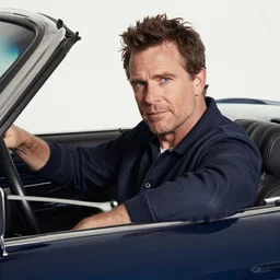 Studio Photo of John Blondell in a car