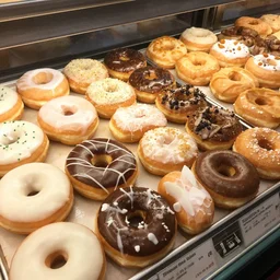 a display case filled with lots of different types of donuts