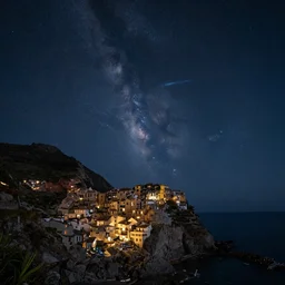 a beautiful double exposure of the astronomy picture of the day, comet exposure, with a rural seaside village landscape at night