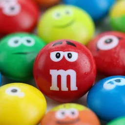 macro closeup of M&M's candy with crazy monsters pictures on them , 8k hd dof