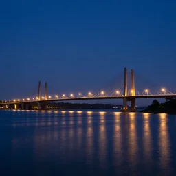 a midnight landscape with bridge and lights and water