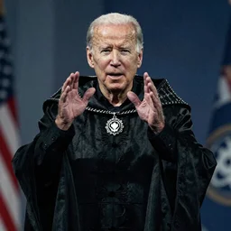 Grainy digital camera footage of Joe Biden performing an ancient ritual while wearing necromancer garments
