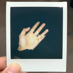 close - up photo of a hand taken with a polaroid