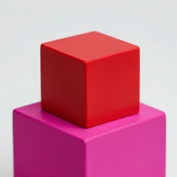 a red cube on top of a magenta cube