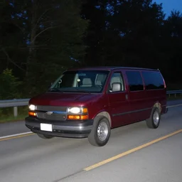 A photograph of a 1999 Maroon Chevrolet Express driving on highway 411 in Perth, Ontario at night at 22:20, photograph taken in 2009 on a nokia flip phone