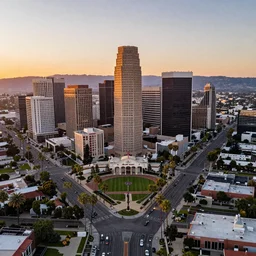 view from a drone, Pasadena California, LA summer sunset, Rose Bowl, California Palm Tree's lining the streets, Downtown US Bank Tower Centered, trending on artstation, 30mm, by Noah Bradley