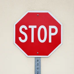stop sign spray painted on a wall