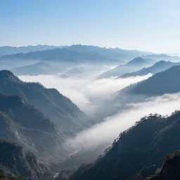 The most beautiful panoramic photo landscape, where the mountains are towering over the valley below their peaks shrouded in mist, the sun is just peeking over the horizon producing an awesome flare and the sky is ablaze with warm colors, lots of birds and stratus clouds. The river is winding its way through the valley ending in a giant dreamy waterfall, the trees are starting to turn yellow and red, aerial view