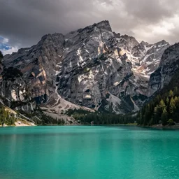 a turquoise placid lake in the foreground with a towering mountain in the background, Carl Friedrich