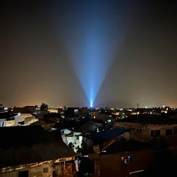 UFO seen during night time in Ajegunle slums of lagos - beaming neon ray of light,