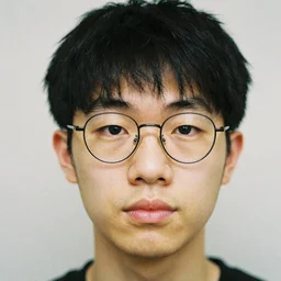pretty asian male, small eyes, circular glasses, two block haircut with bangs, fleshy nose, feminine eyes, thin lips, clean shaven, 3 5 mm film, portrait by annie liebovitz