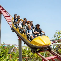 a dinosaur riding a roller coaster